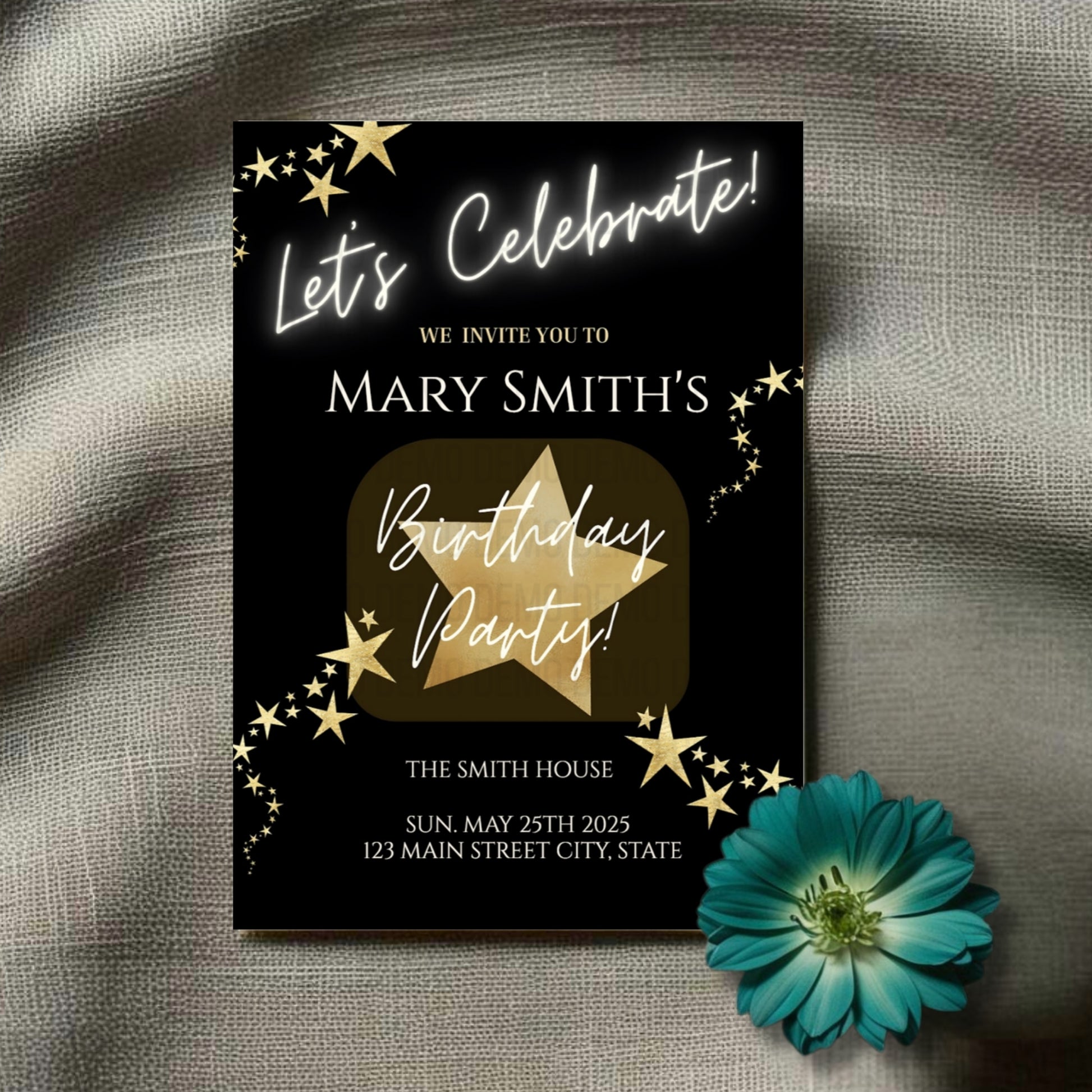 Birthday party invitation with gold star design on a textured surface with a blue flower.