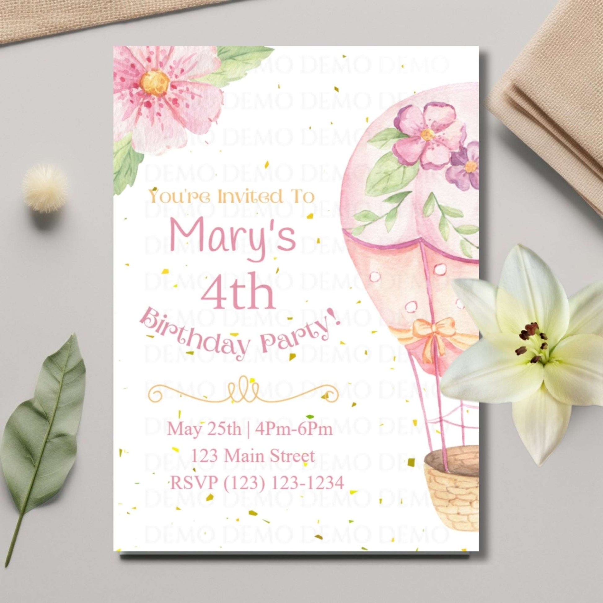 Birthday party invitation with pink balloons and flowers on a light gray surface.