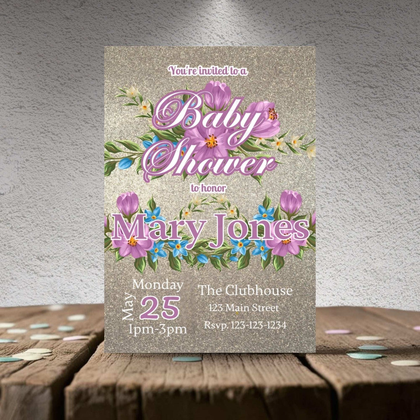 Baby shower invitation with floral design on a textured surface