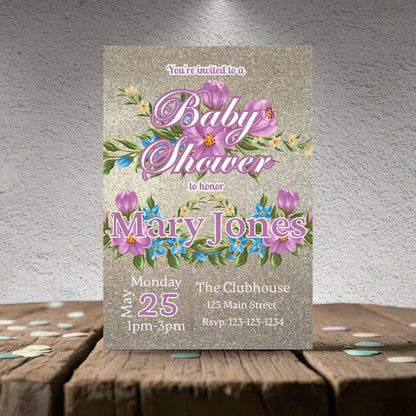 Baby shower invitation with floral design on a textured surface