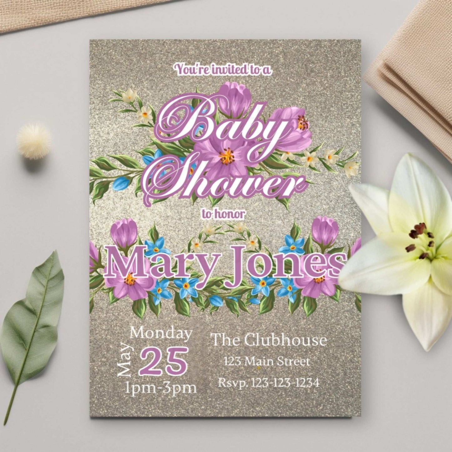 Baby shower invitation with floral design on a light surface