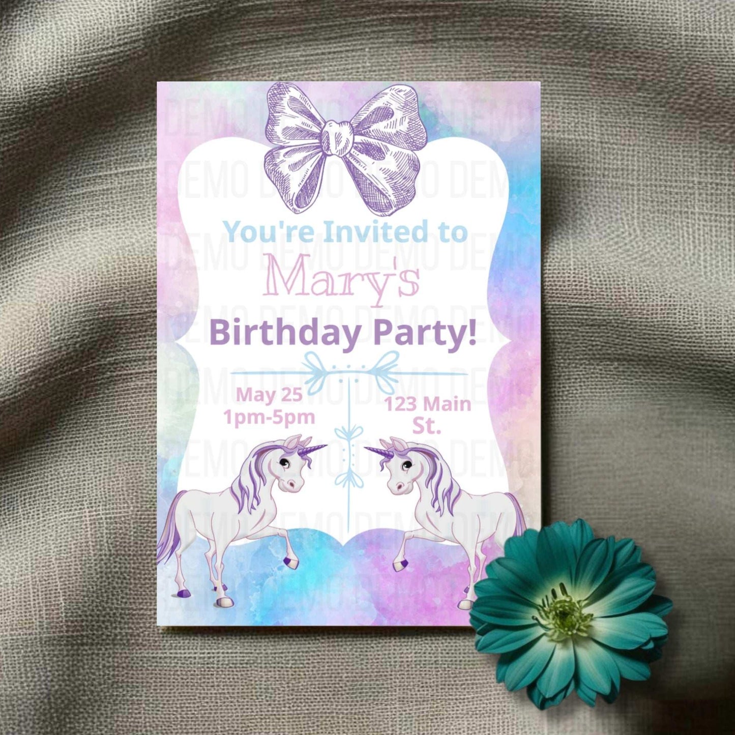 Birthday party invitation with unicorns and a butterfly on a textured surface with a flower.