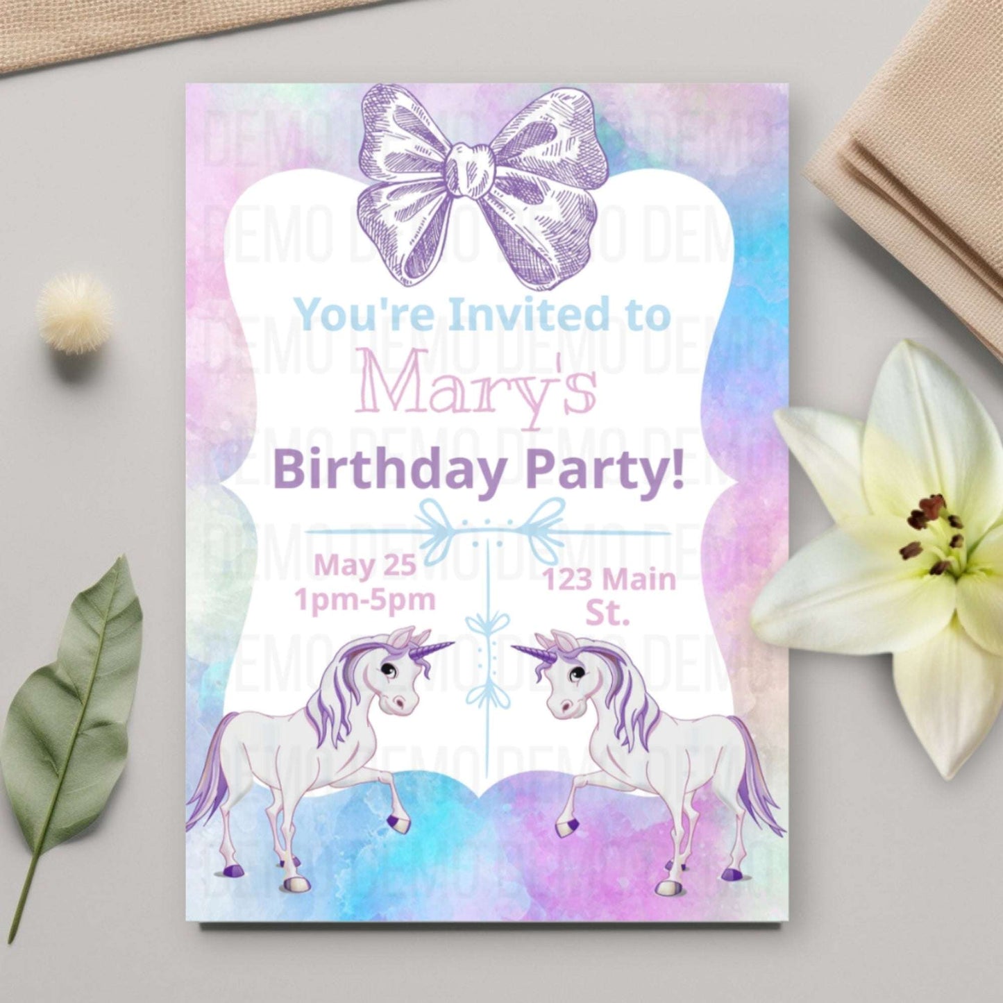 Birthday party invitation with unicorns and a bow on a colorful background