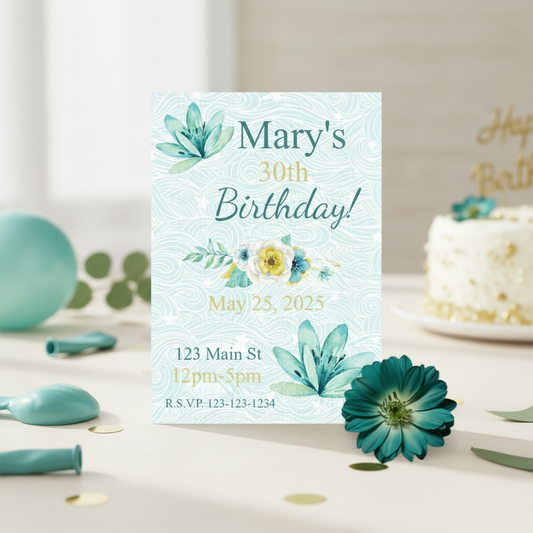 Birthday invitation card with floral design on a table with cake and decorations