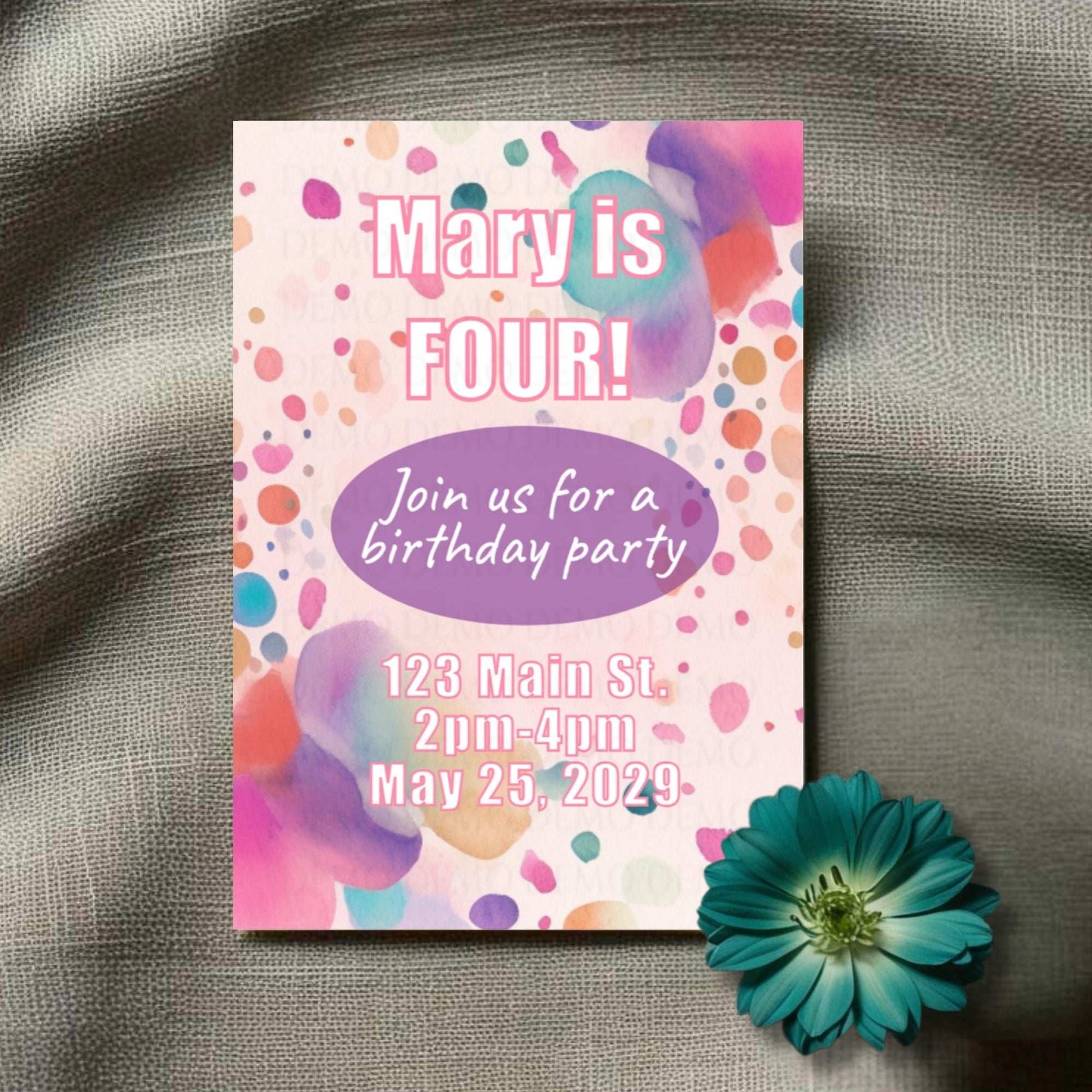 Birthday party invitation with colorful polka dots and a flower on a textured surface