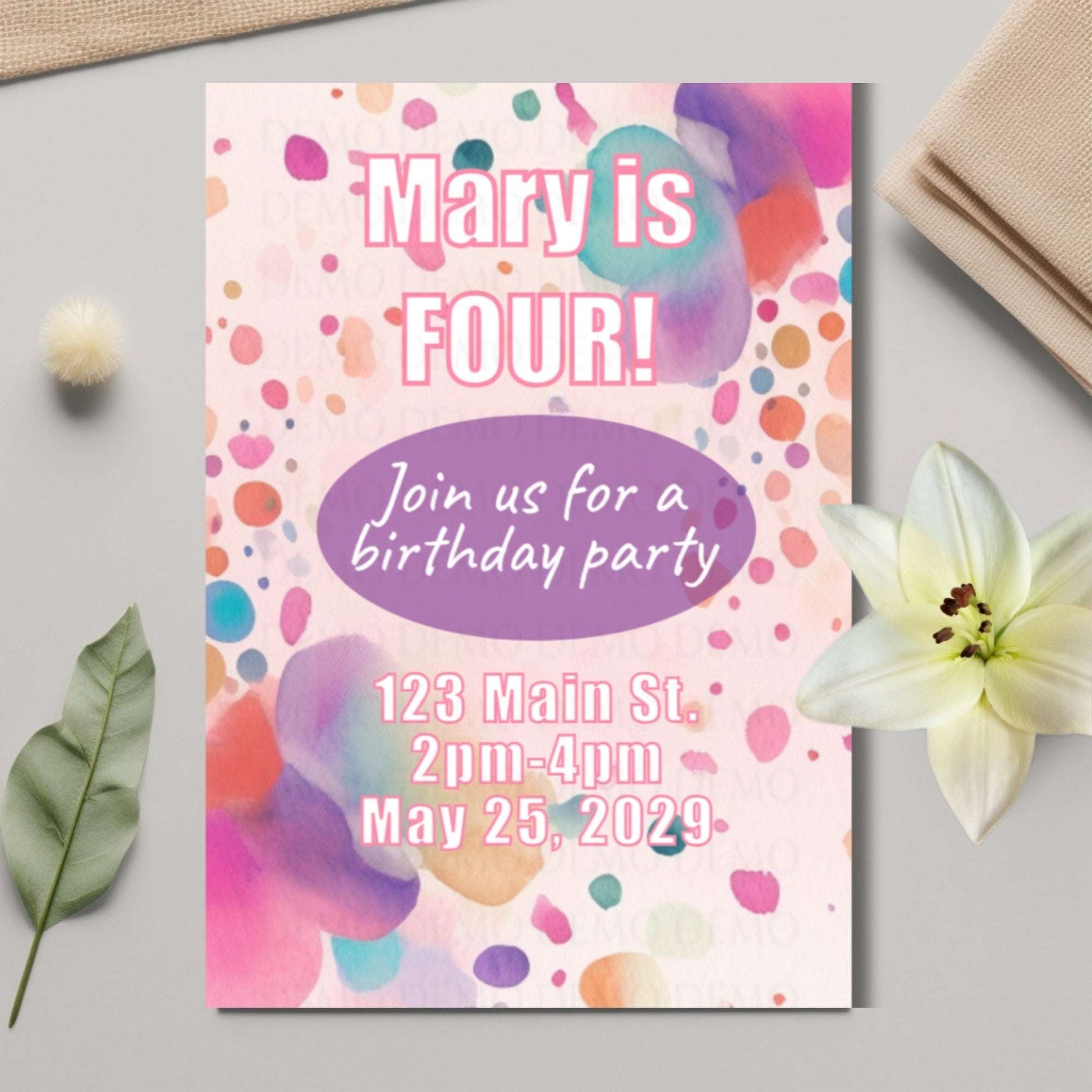 Birthday party invitation with colorful confetti design on a light gray surface.