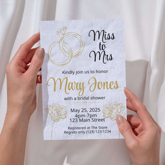 Bridal shower invitation held by hands with a white background