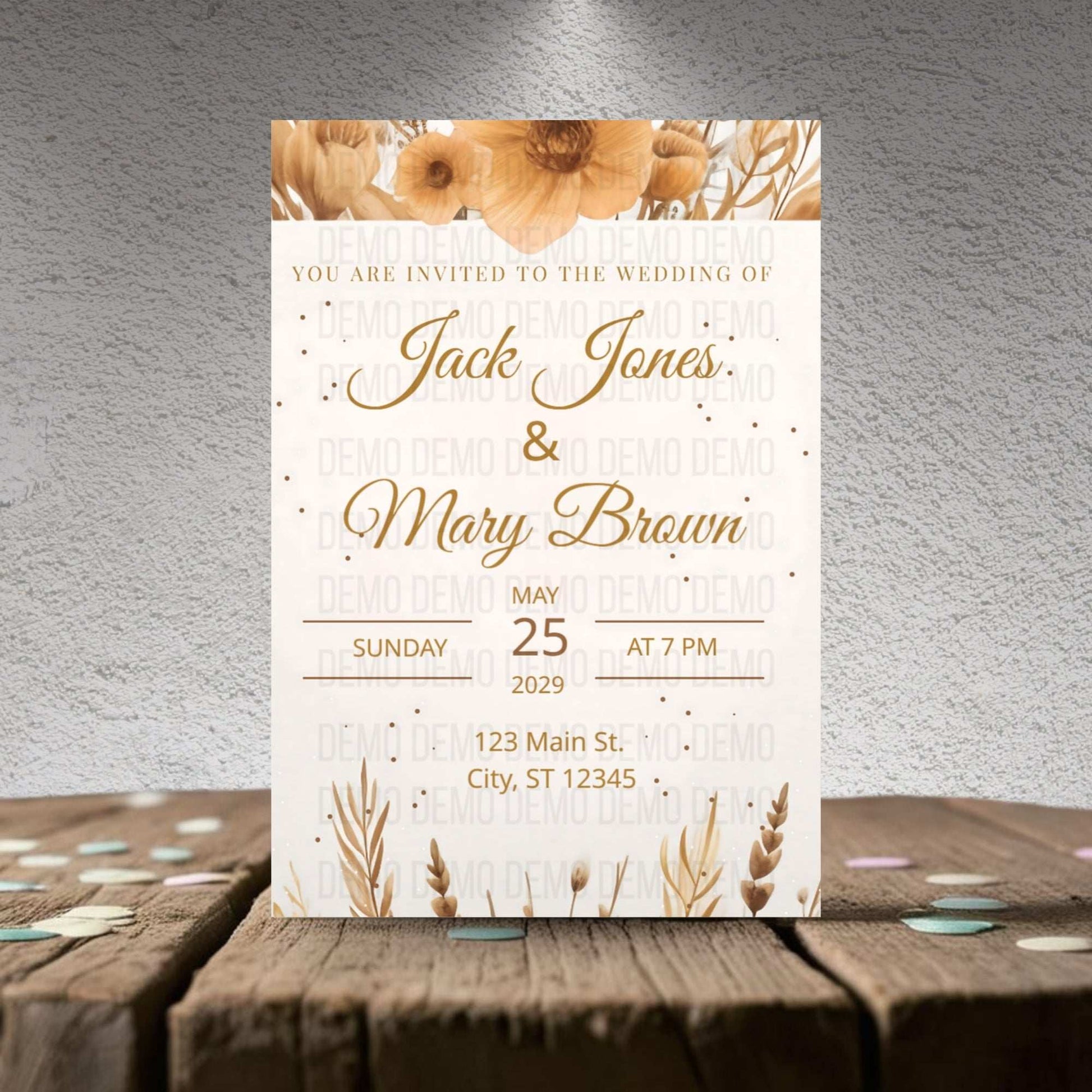 Wedding invitation card with floral design on a wooden surface and gray textured background