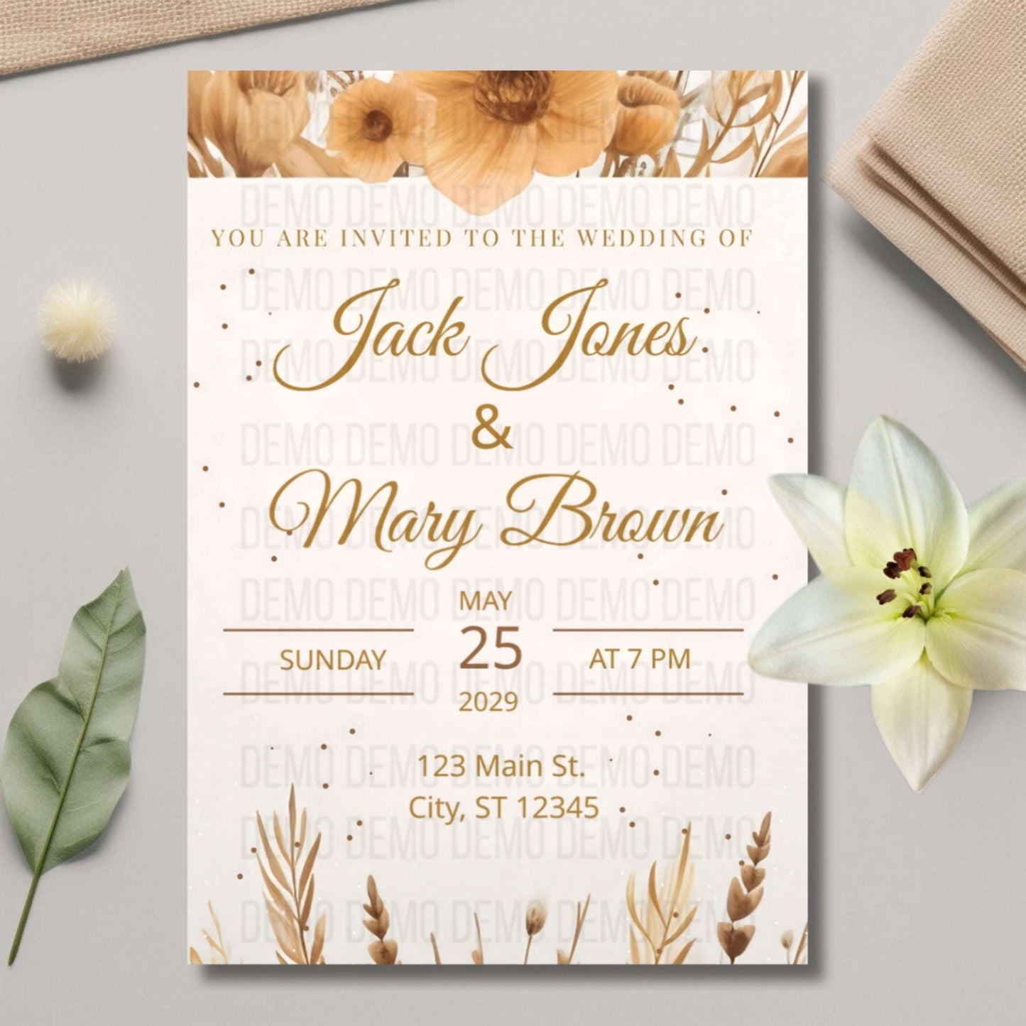 Wedding invitation card with floral design on a light gray surface