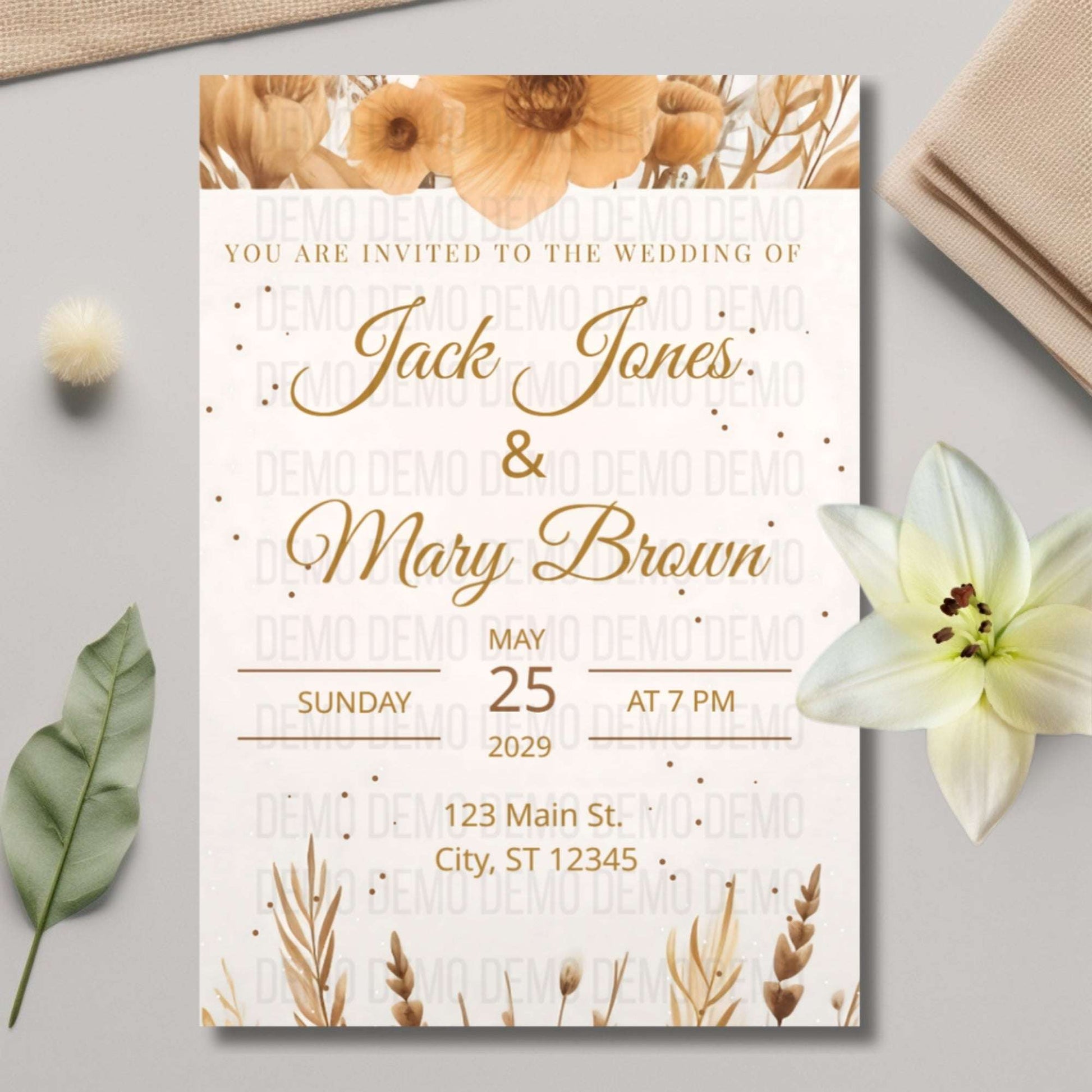 Wedding invitation card with floral design on a light gray surface