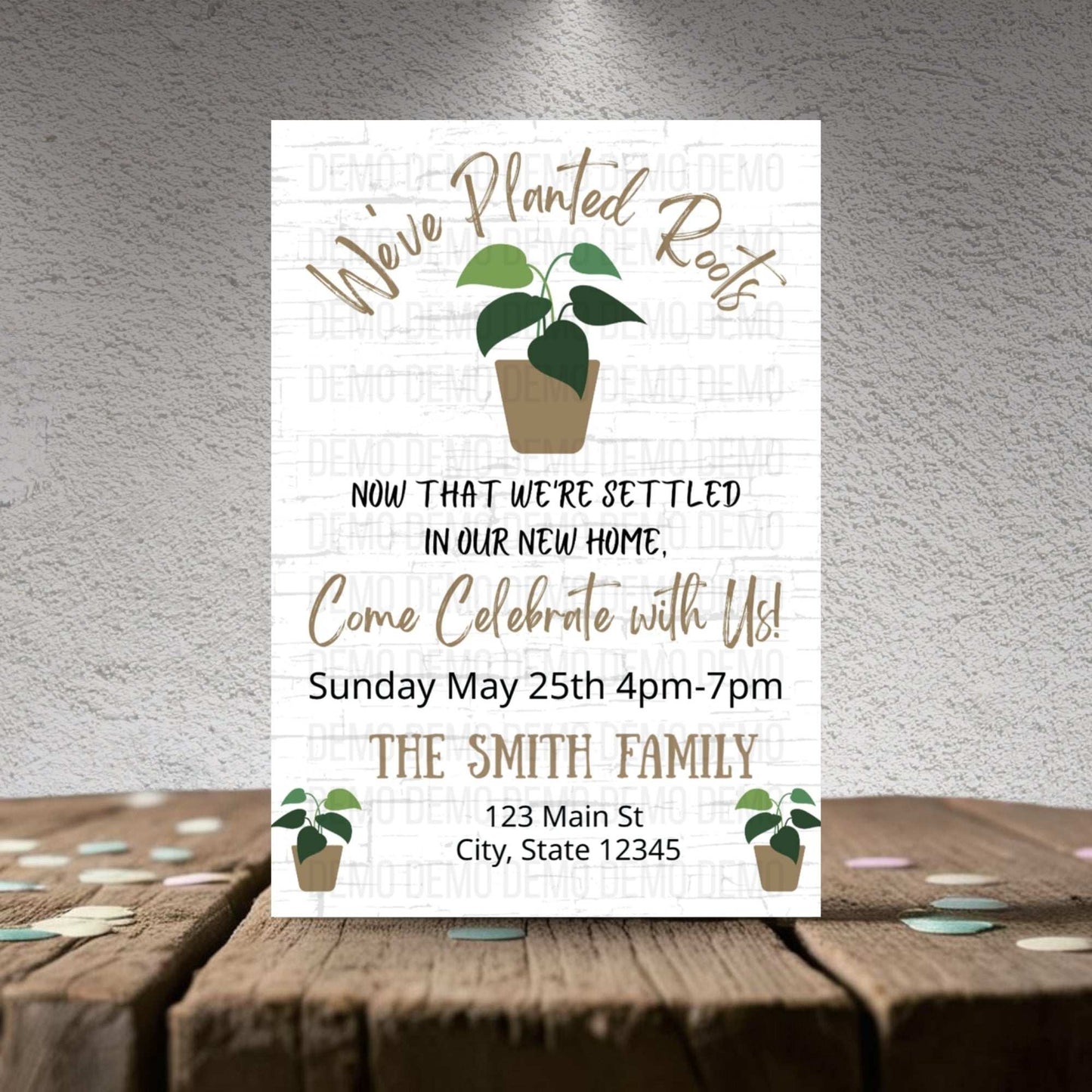 Invitation card with plant illustrations on a wooden surface and gray background