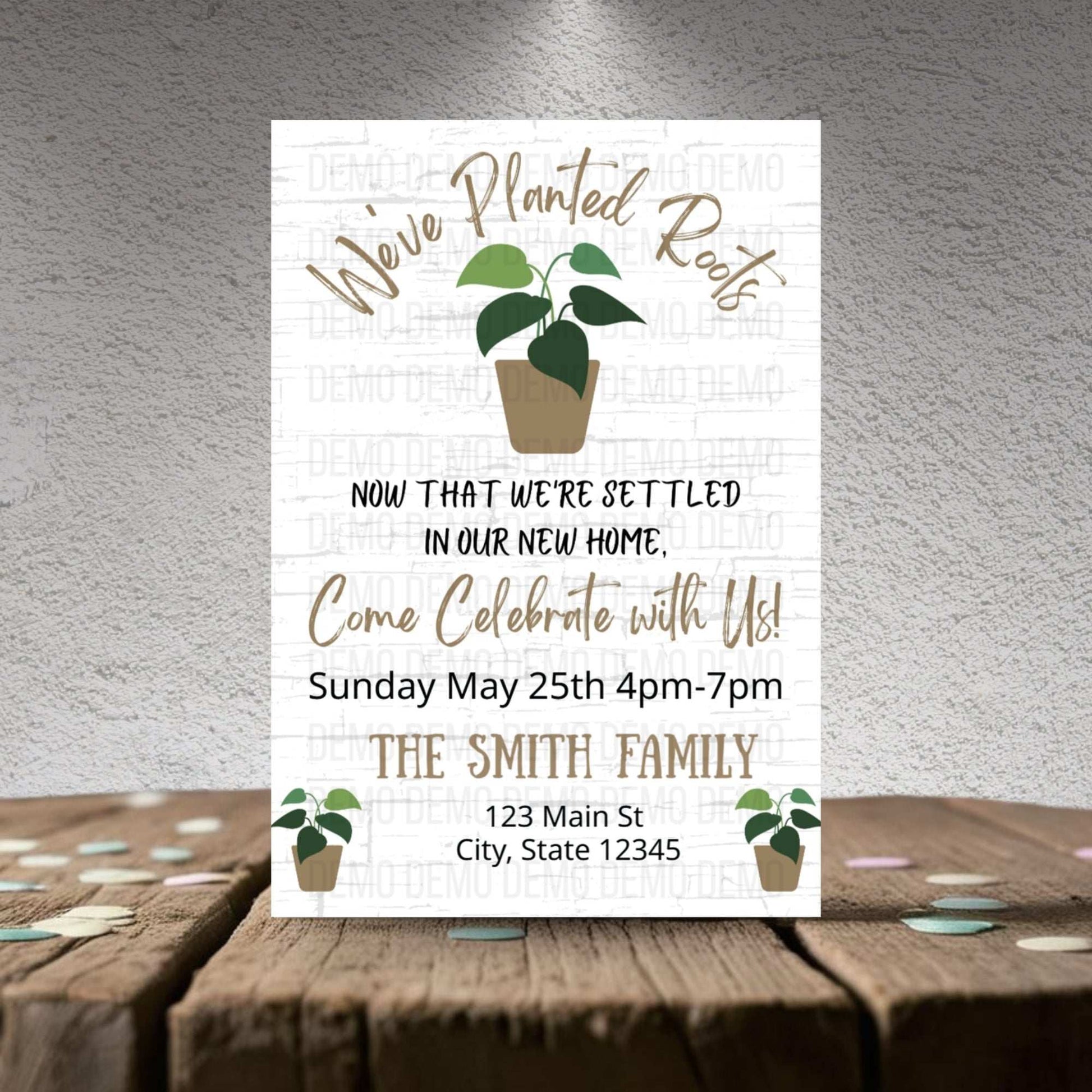 Invitation card with plant illustrations on a wooden surface and gray background