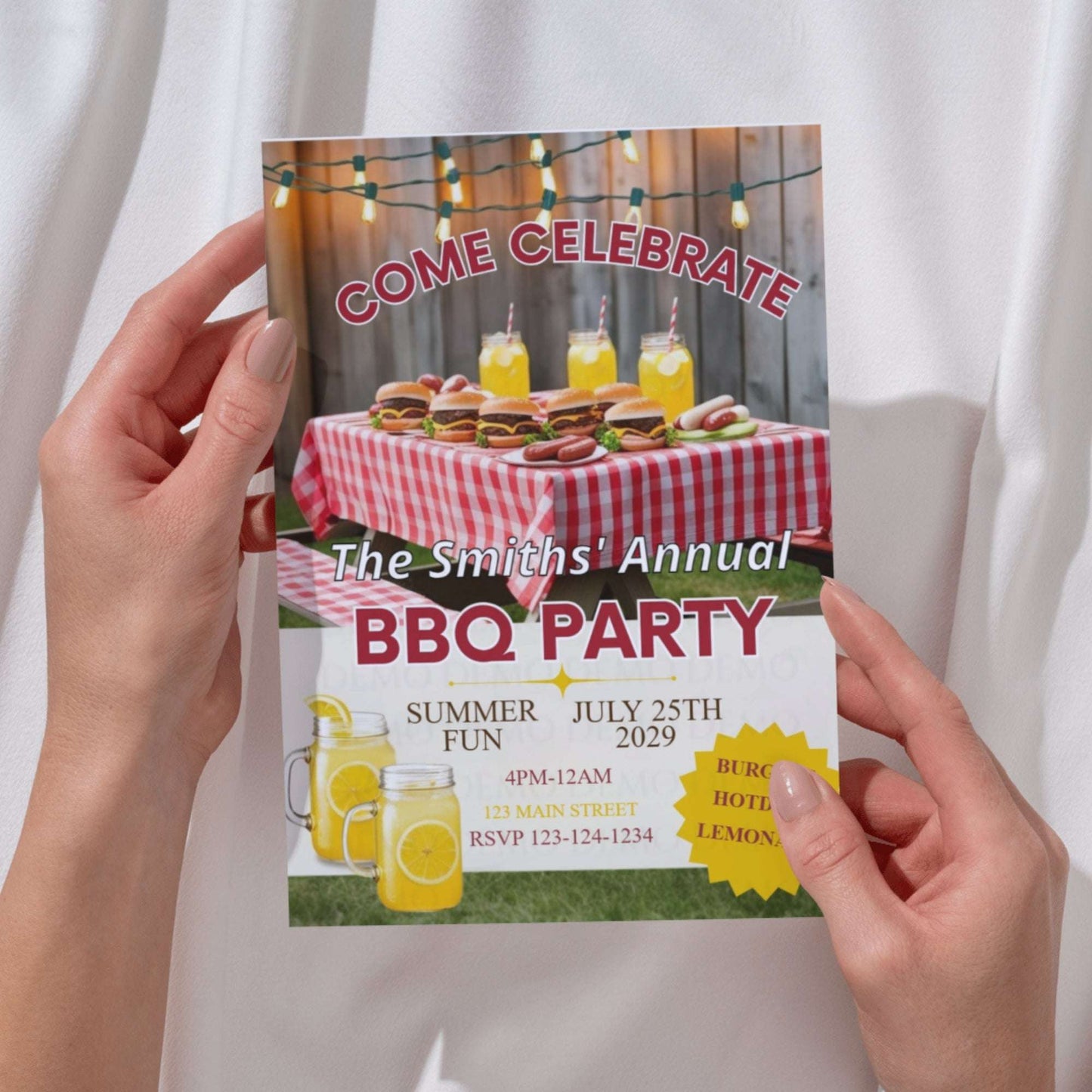 Hand holding a BBQ party invitation with food and drink graphics.