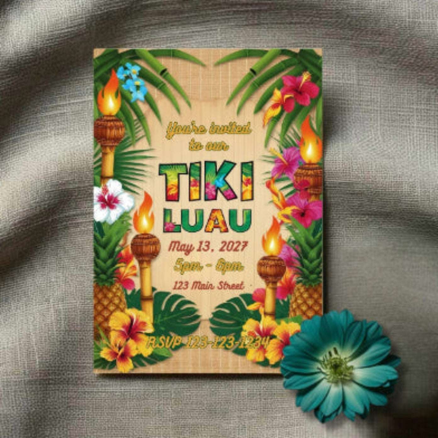 Tiki Luau invitation with tropical elements on a textured surface.