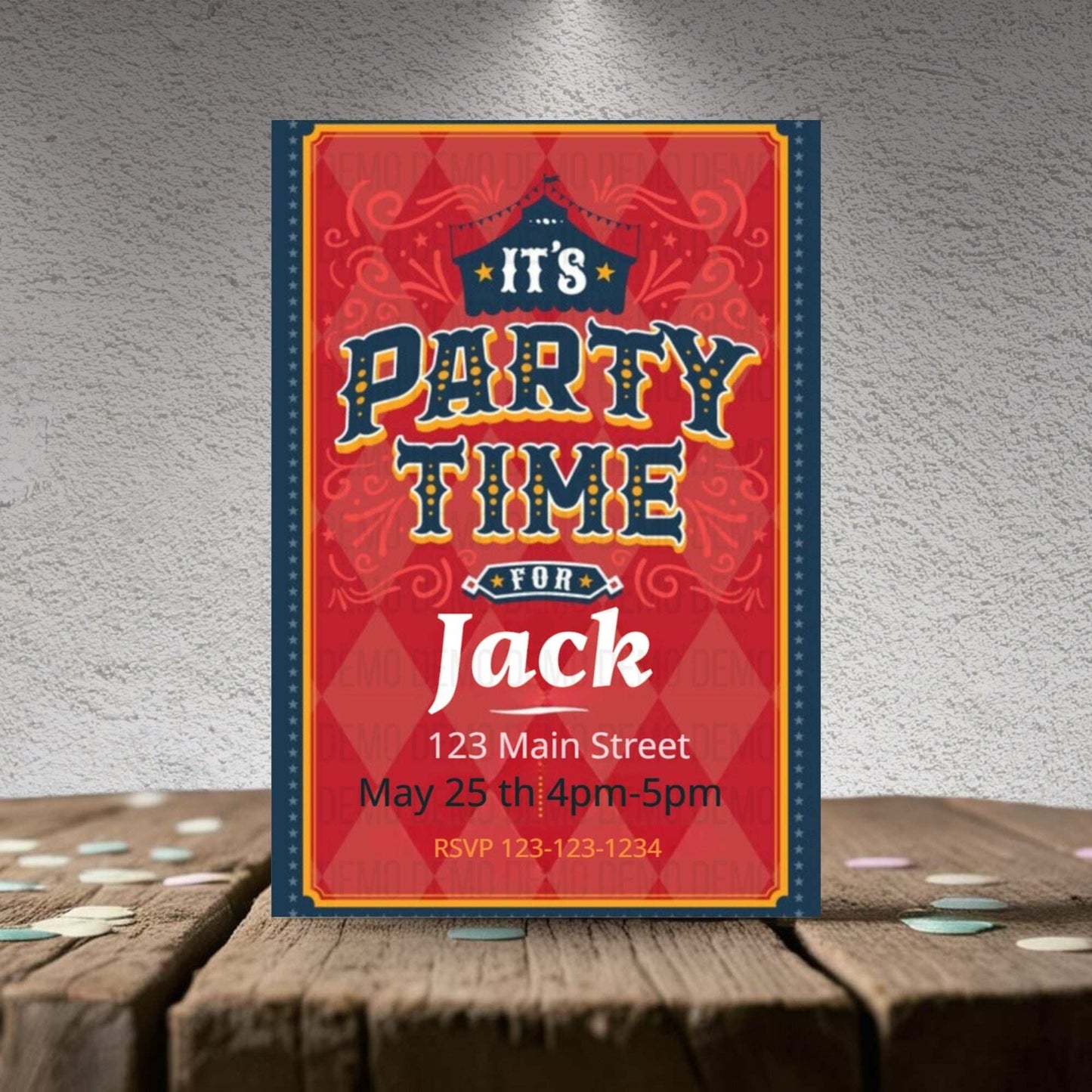 Party invitation card for 'It's Party Time for Jack' on a wooden surface with a textured gray background.