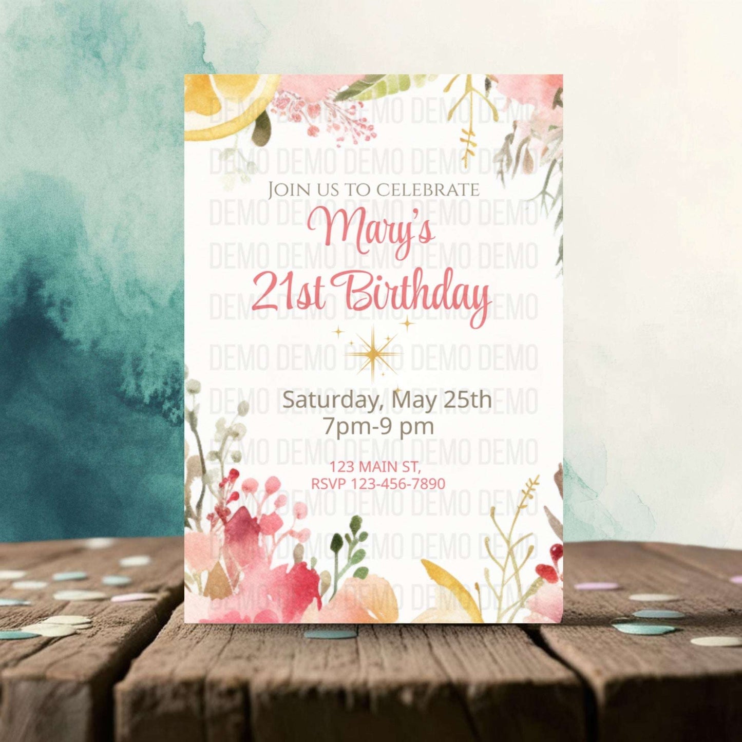 Invitation card for Mary's 21st birthday with floral designs on a wooden surface.