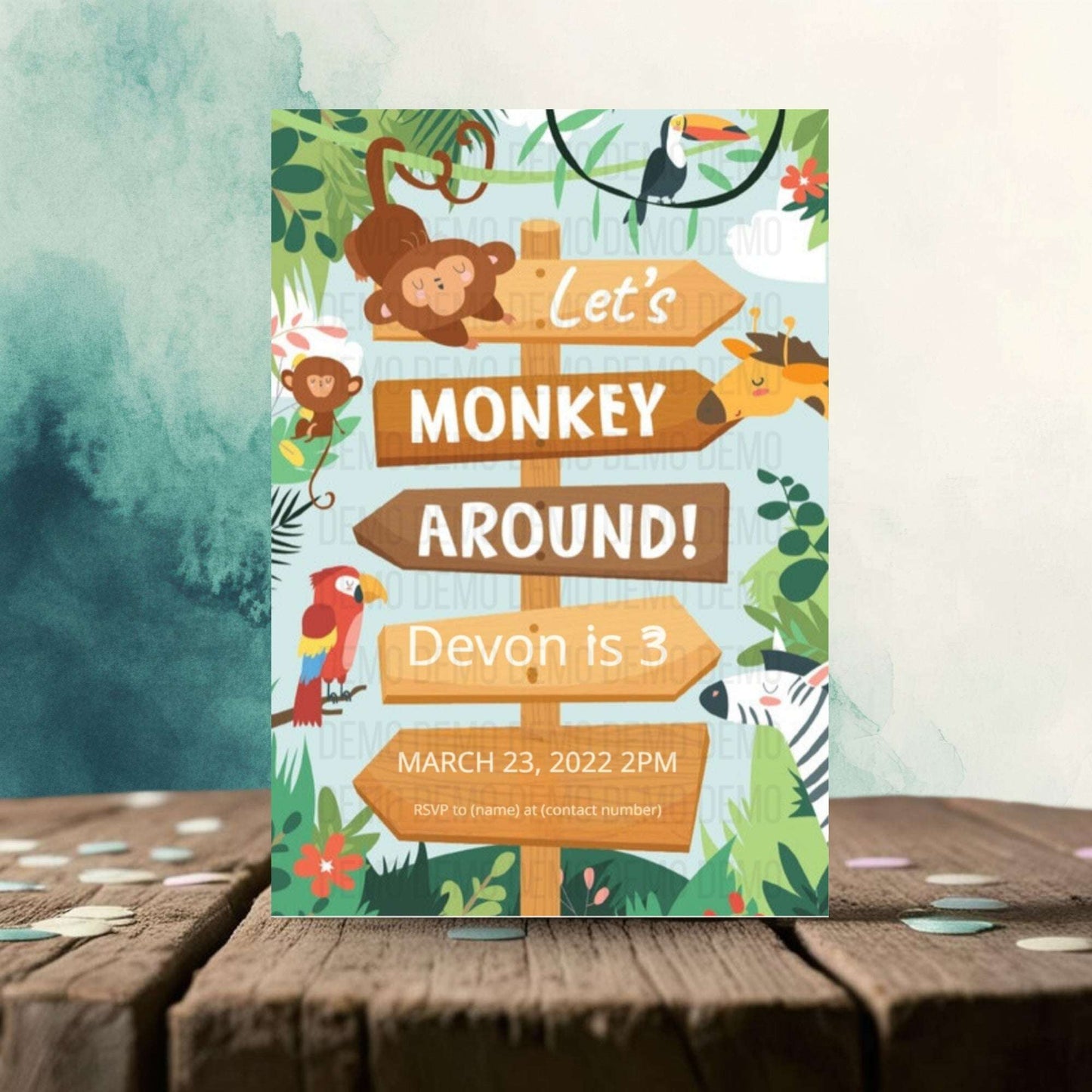 Children's birthday party invitation with monkey and jungle theme on a wooden surface.