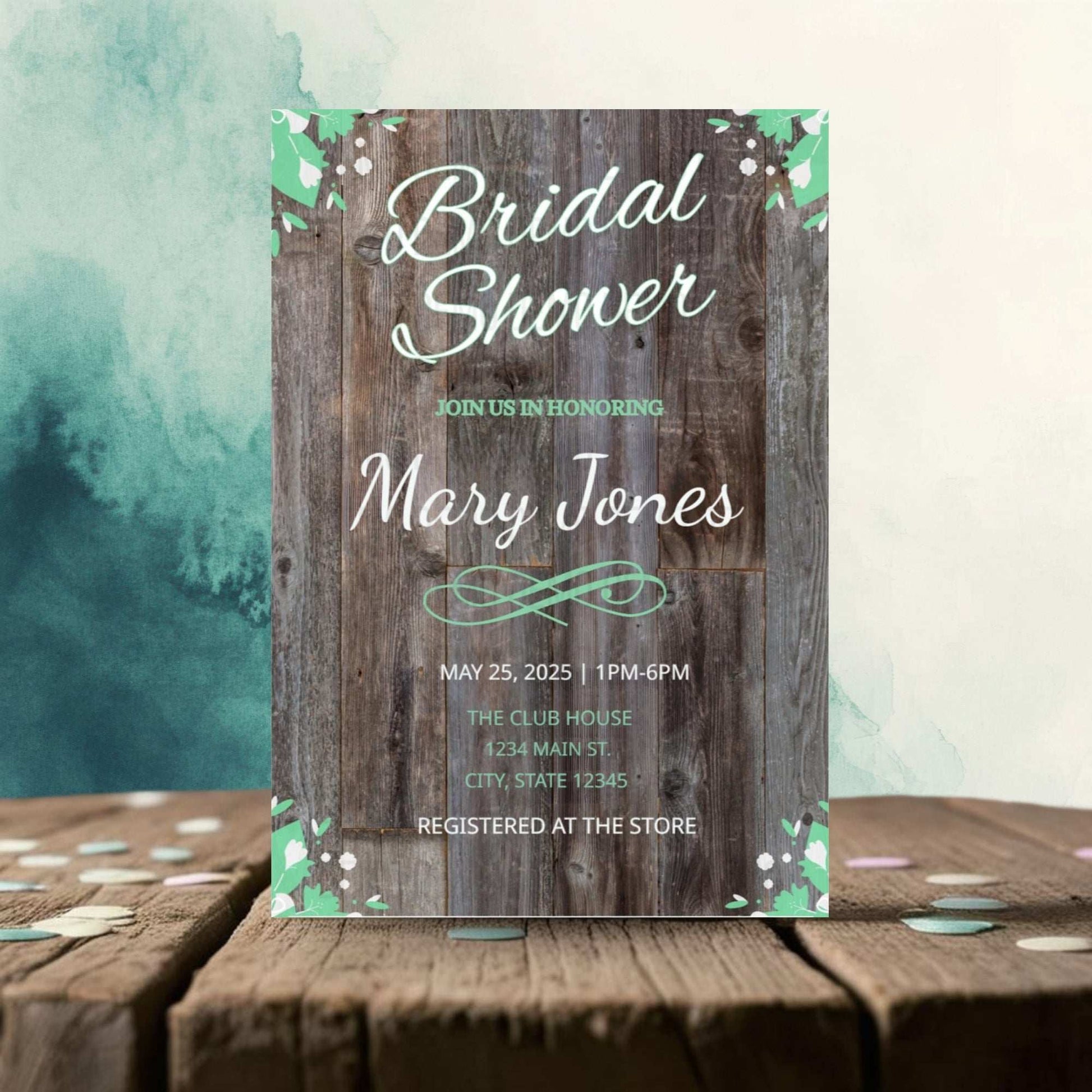Bridal shower invitation with wooden texture and floral elements on a wooden surface.